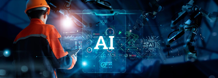 Jak wdrożyć AI w biznesie – Ciemnoniebieska grafika z napisem "AI" na środku, z lewej strony widoczna ręka człowieka w roboczym kombinezonie, z tabletem