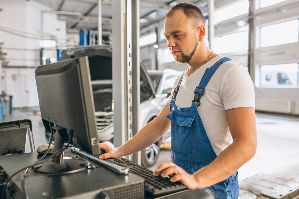 digital transformation costs (man on the shop floor in front of a computer)