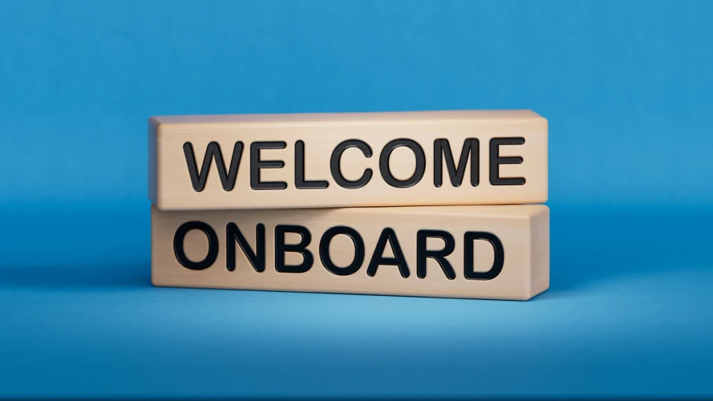 How to deploy an employee (two wooden rectangular blocks with the words welcome and onboard on a blue background)
